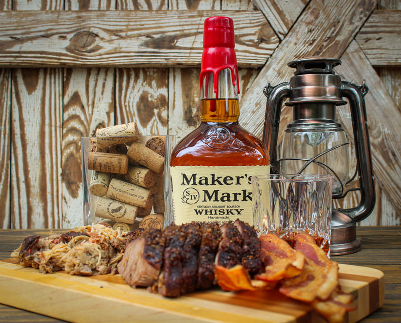 A bottle of Maker's Mark whisky with bacon and barbecue